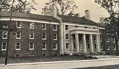 Seaton Hall, a large dormitory building with columns at the front entrance, on a college campus.